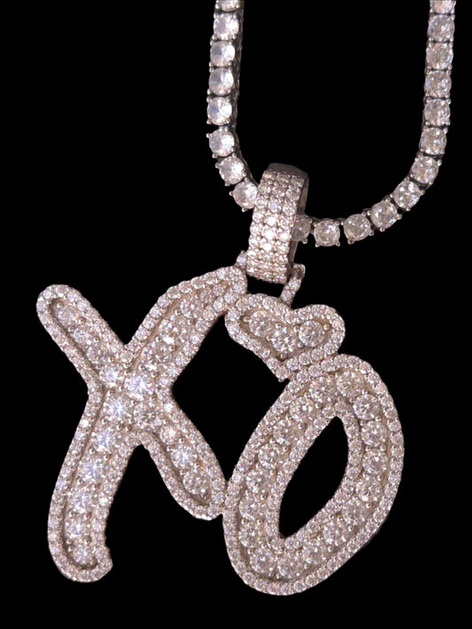 Silver jewelry with a design on a textured dark surface